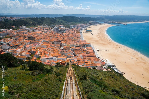 Fototapeta Panoramic View of Nazare Coastal Town with Red Rooftops and Atlantic Ocean in Portugal