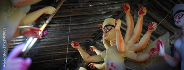 Fototapeta Yellow Painted Maa Durga Idol in Process During Durga Puja Preparation