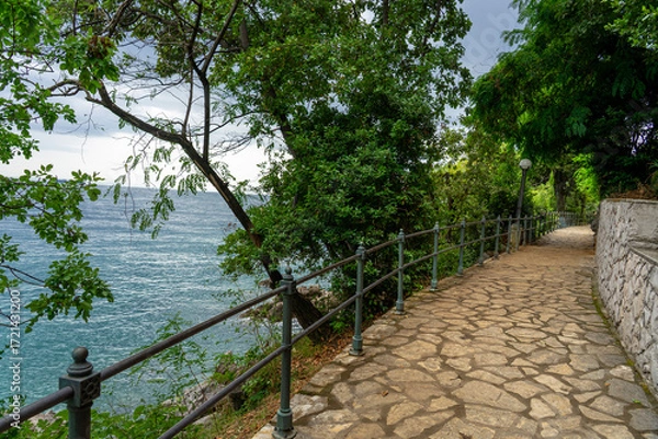 Fototapeta Stone seaside path Lungomare with railing along Adriatic coast in Opatija, Croatia
