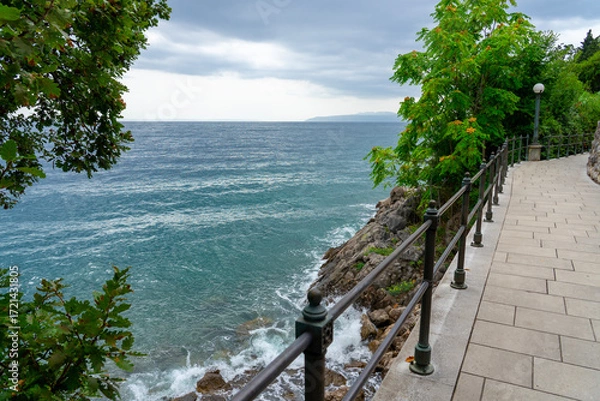 Fototapeta Stone seaside path Lungomare with railing along Adriatic coast in Opatija, Croatia