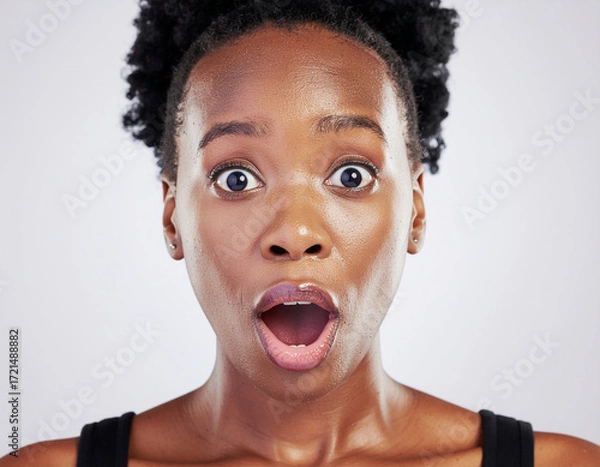 Fototapeta Studio portrait of a surprised woman on white background