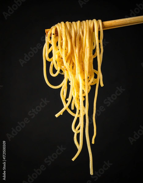 Obraz Delicious Noodles Being Held With Chopsticks Against Black Background