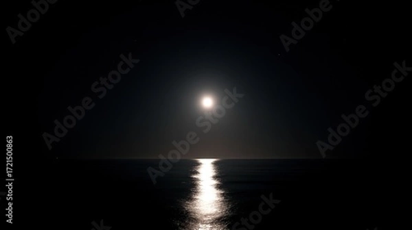 Fototapeta A bright full moon shines over the surface of the sea, its soft light dancing on the water, highlighting the tranquility of the moonlight and the ocean, creating a serene nighttime coastal scene.