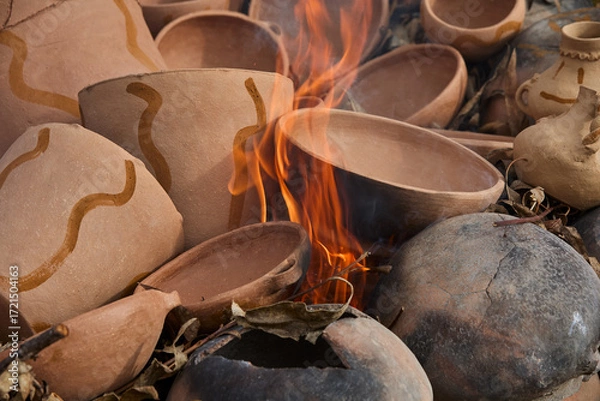 Fototapeta the firing process of clay pottery in Huancas brings earth to life. Each vessel, shaped by ancestral hands, hardens in the heat, transforming into a timeless symbol of tradition, resilience, and cultu