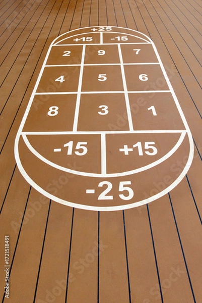 Fototapeta The classic shuffleboard court, ready to be played on a ships deck. a symbol of tranquility and fun on board a cruise.