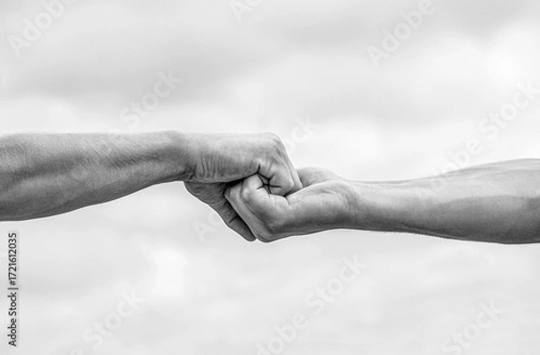 Fototapeta Teamwork, friendship. Rescue, helping gesture or hands. Two hands, helping arm of a friend, teamwork. Black and white