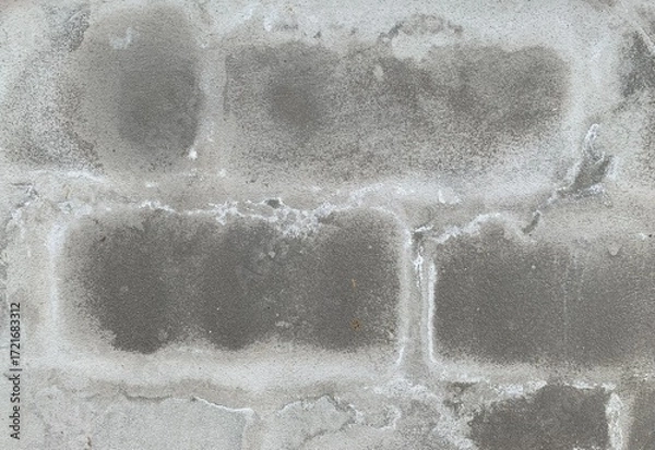 Fototapeta A close-up texture shot of an old, weathered gray concrete block wall showing signs of wear and water damage.