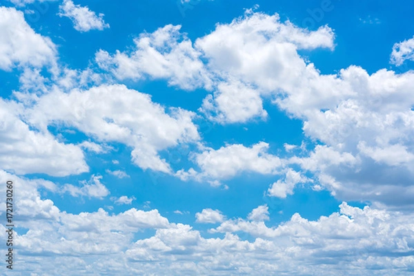 Fototapeta Beautiful blue sky with scattered clouds for background and texture.