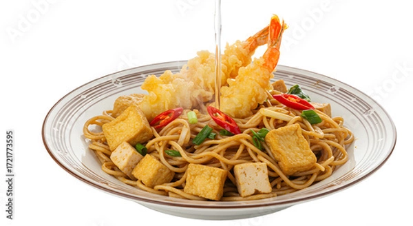 Fototapeta Plate of Asian stir-fried noodles with tofu cubes and crispy tempura shrimp, served on white patterned dish, perfect for seafood meals