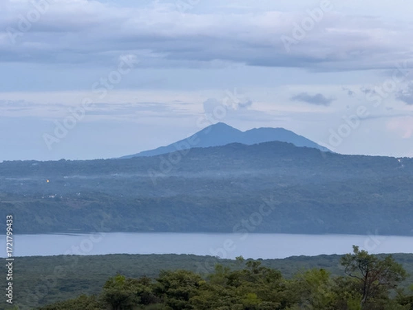 Fototapeta Mountains overlooking a tranquil lake at dusk