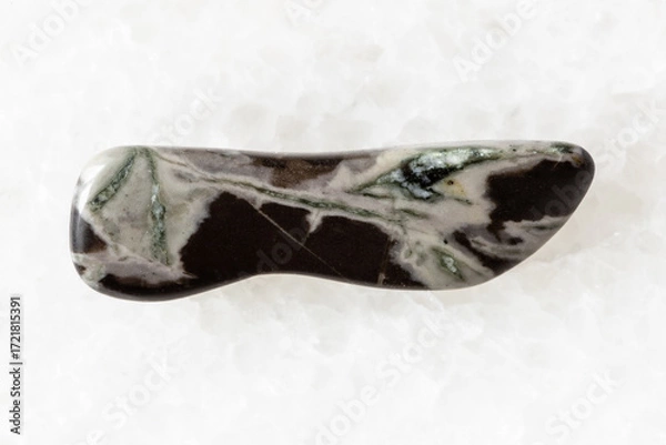 Obraz sample of tumbled hornfels rock on white marble