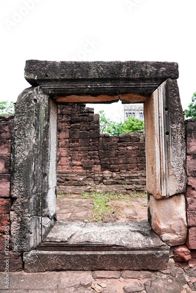 Fototapeta Phimai Historical Park, ancient rectangular complex of temples features intricate carvings & stone sculptures at Phimai District, Nakhon Ratchasima Province, Thailand. Vertical.