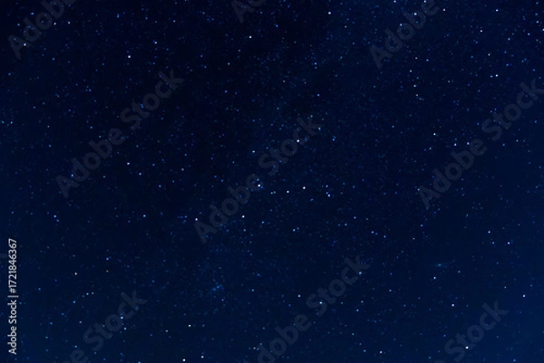 Obraz Night sky scattered stars. Celestial canvas dark blue background with glimmering star points cosmos backdrop. Deep space dreamscape infinite galaxy of hope dark blue starry sky.