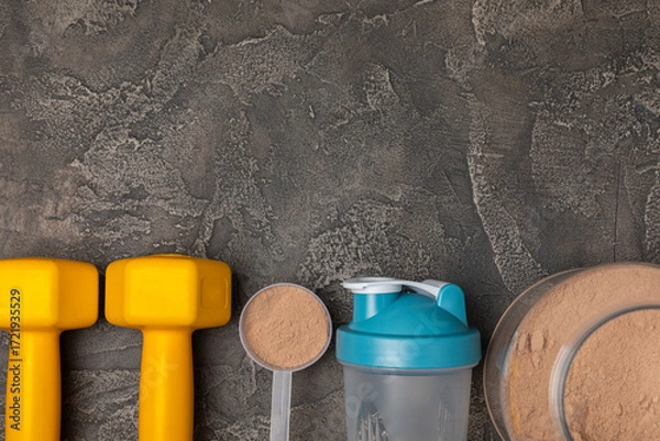 Fototapeta Protein shake with protein powder on a colored background. The powder is mixed with water or milk. A dietary supplement for a balanced diet. Whey protein. Fitness and gym diet nutrition.