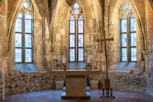 Obraz Medieval stone chapel interior with altar and cross
