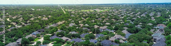 Fototapeta Panorama aerial view downtown Fort Worth Texas background from Colleyville, residential street along row upscale two-story suburban homes nestled in mature trees, pools, dense greenery backyard