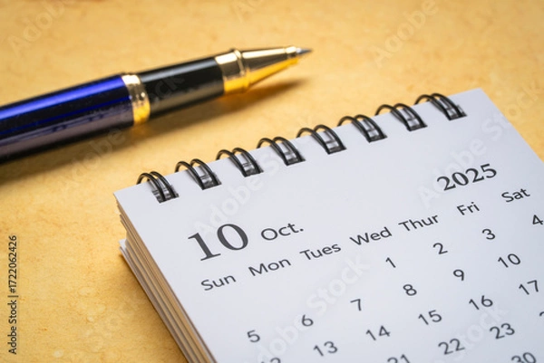 Fototapeta October 2025 - small spiral desktop calendar, time and business concept