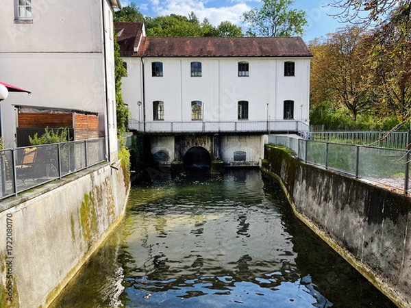 Fototapeta Canal side building over water in Furstenfeldbruck Germany with arches and white facade