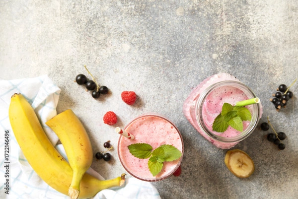 Fototapeta Refreshing mixed berry and banana smoothie with mint garnish.