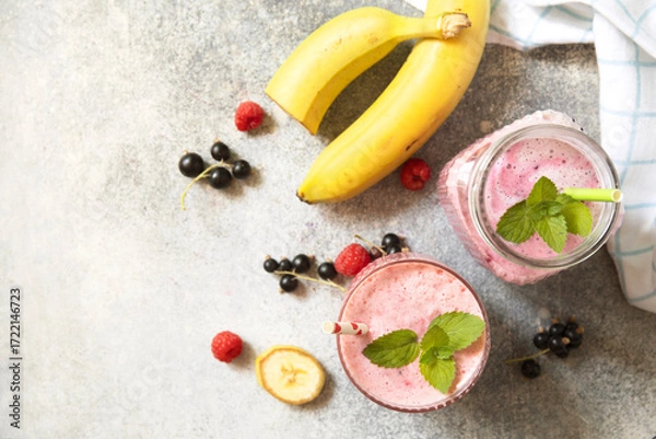 Fototapeta Refreshing mixed berry and banana smoothie with mint garnish.