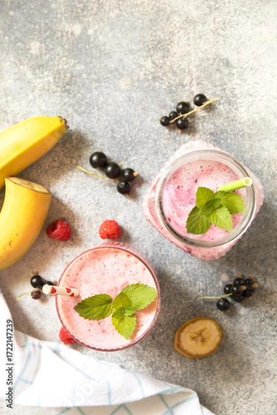 Fototapeta Refreshing mixed berry and banana smoothie with mint garnish.