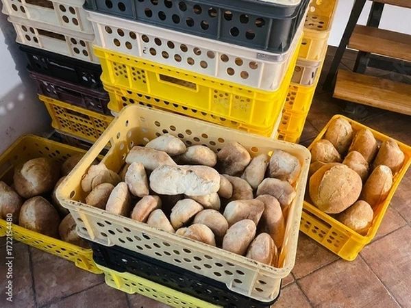 Fototapeta Food commerce and everyday shopping. Sale of bread with a close-up view of bakery products on shelves in a store or bakery.