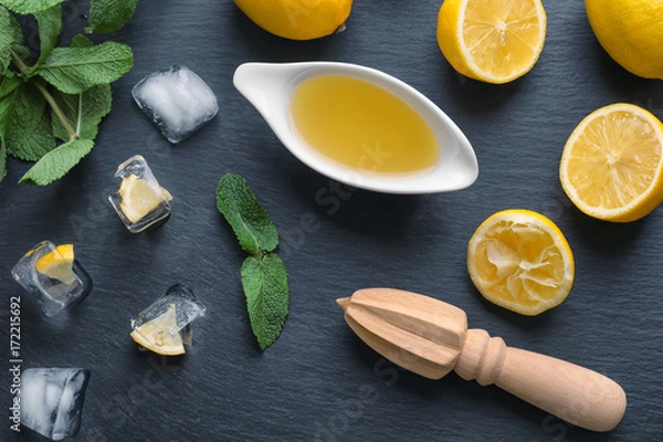Fototapeta Composition with lemon juice, ice and squeezer on table