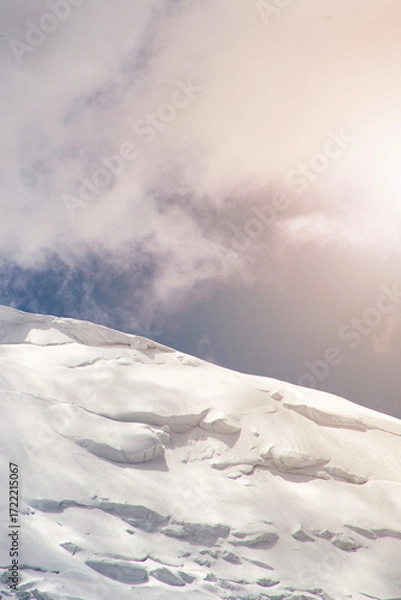 Fototapeta A close-up of a mountain peak in bad weather, leading to the death of climbers in windy weather, snow-capped peaks in the clouds