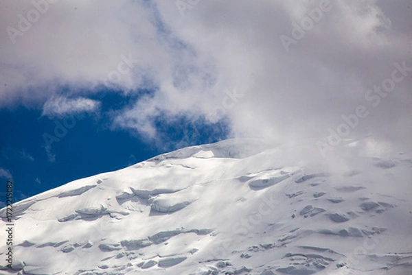 Fototapeta A close-up of a mountain peak in bad weather, leading to the death of climbers in windy weather, snow-capped peaks in the clouds