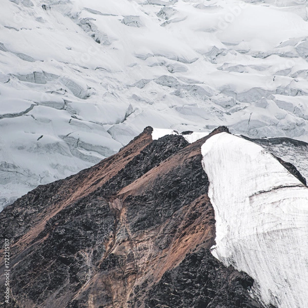 Fototapeta A close-up of a mountain peak in bad weather, leading to the death of climbers in windy weather, snow-capped peaks in the clouds