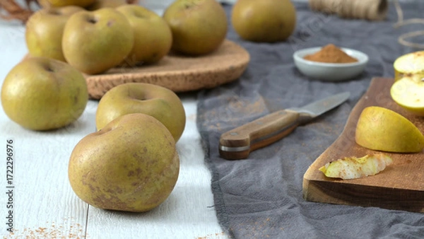 Fototapeta Cinnamon Sprinkled Sliced Apples on a Cutting Board