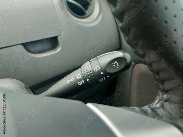 Fototapeta The image displays a car's light and turn signal stalk, typically located on the left side of the steering column