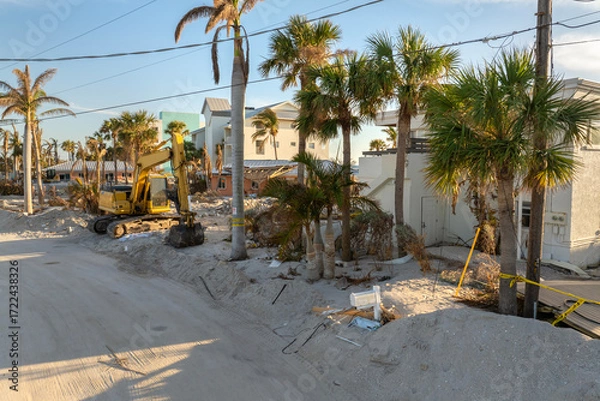 Fototapeta Piles of garbage from severely damaged homes after hurricane Milton storm surge in Florida. Debris on street side on Manasota Key in Englewood. Hurricane aftermath cleanup
