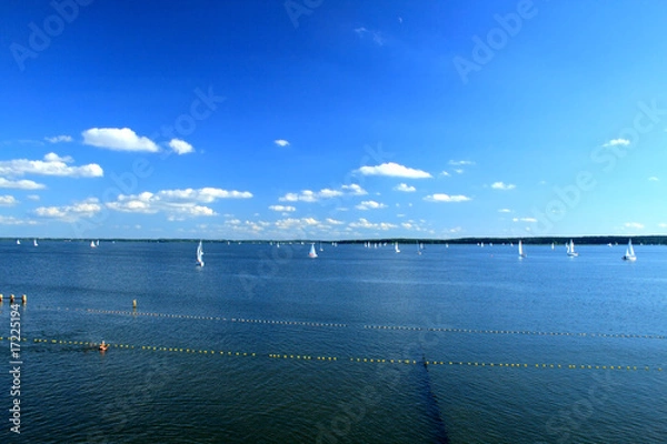 Obraz Yachts sailing on the lake under colorful sky