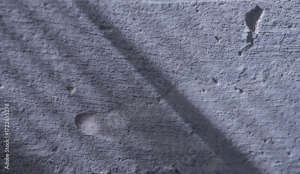 Fototapeta Gray concrete wall with shadow. Abstract background and texture for design.