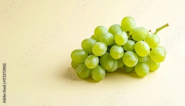 Obraz Lush green grapes, still life, against a soft, light yellow backdrop, studio shot.
