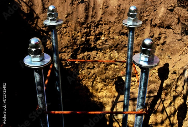 Fototapeta shiny metallic chrome color stainless steel threaded rod reinforcement. rusty stirrups bars. blurred background. construction concept. building site. building industry. closeup view.