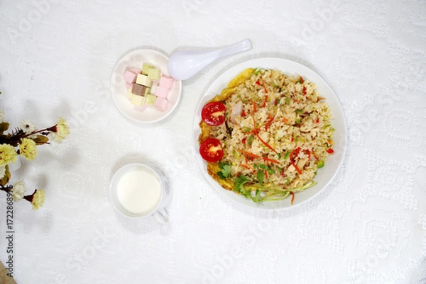 Obraz Close-up of egg fried rice, milk, assorted flavored sugar cubes, top view