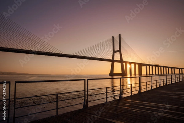 Fototapeta Sunrise Over Vasco da Gama Bridge Spanning the Tagus River in Lisbon, Portugal