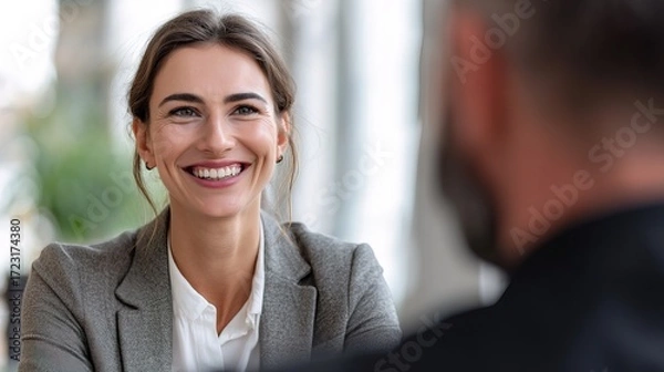 Fototapeta Young graduate excelling in job interview at corporate office professional setting close-up view engaging interaction for career success