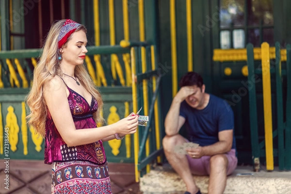 Fototapeta Gypsy fortune teller scam with woman taking money from client after tarot reading