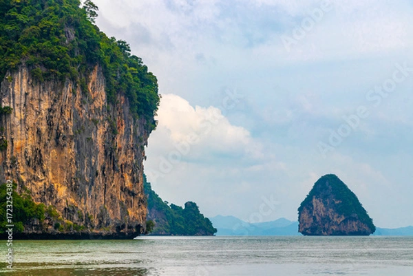 Fototapeta Limestone rocks hills turquoise blue water Phang Nga Bay Thailand.