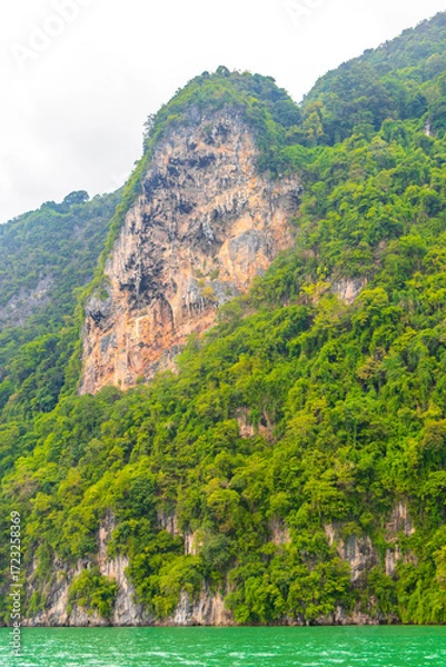 Fototapeta Limestone rocks hills turquoise green water Phang Nga Bay Thailand.