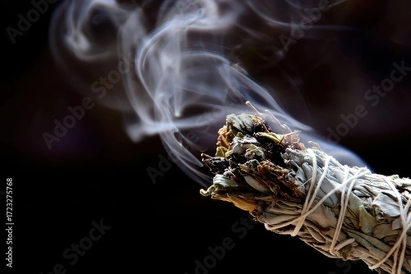 Fototapeta Smoking Sage Bundle with Curled Smoke Against Dark Background.