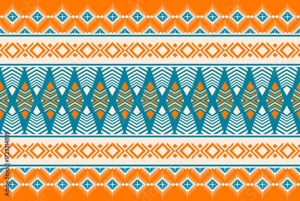 Fototapeta Colorful geometric ethnic seamless pattern with traditional tribal ornaments in orange, teal, and white. Perfect for textile design, fabric prints, wallpapers, and decorative backgrounds.