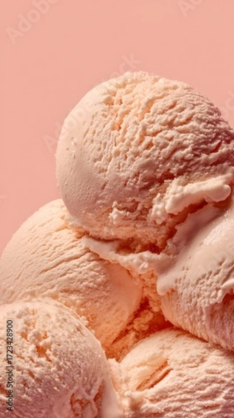 Fototapeta Stacked scoops of peach ice cream against a soft pink backdrop, highlighting the creamy texture and vibrant color, ideal for summer treats and dessert inspiration