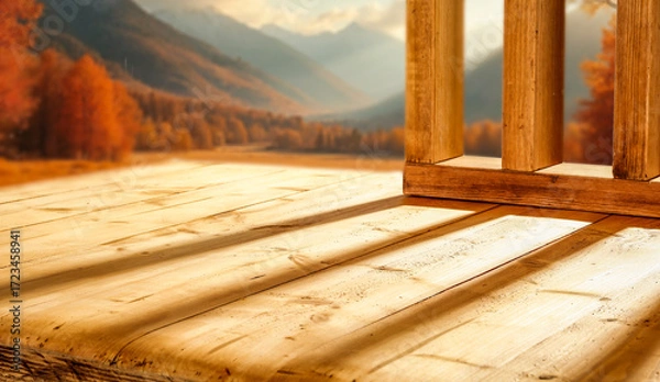 Fototapeta Empty wooden patio surface outdoors with warm autumn sunlight rays shining across the scene with copy space for product placement. The blurred autumn background and cozy seasonal mood. 