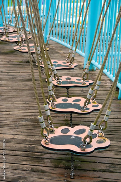 Fototapeta a fun and adventurous paw-print suspension bridge