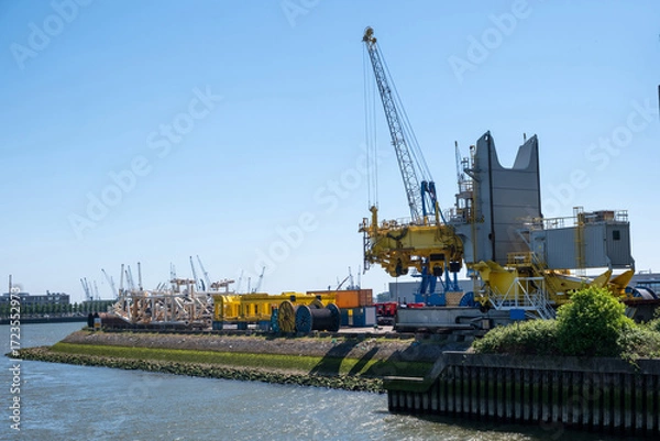 Fototapeta Port of Rotterdam, Netherlands. Cargo ships and cranes loading, Logistics business