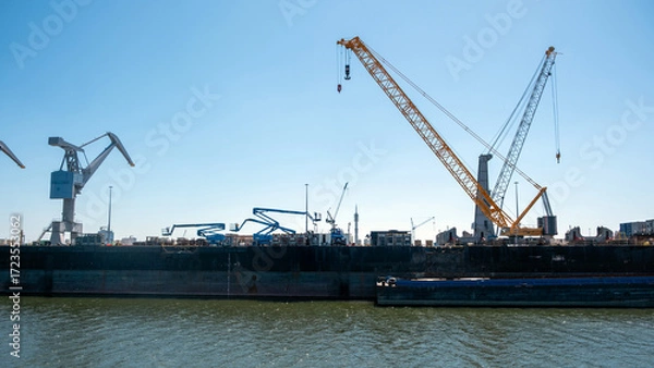 Fototapeta Port of Rotterdam, Netherlands. Cargo ships and cranes loading, Logistics business